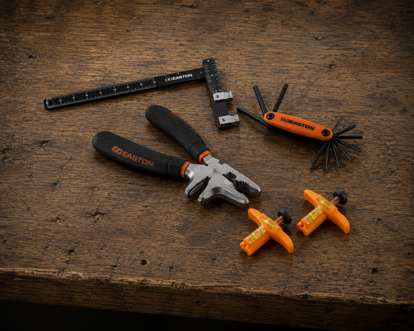 Bow tuning tools on workbench – Easton Archery d-loop pliers, allen wrenches, levels – October Mountain Products archery accessories