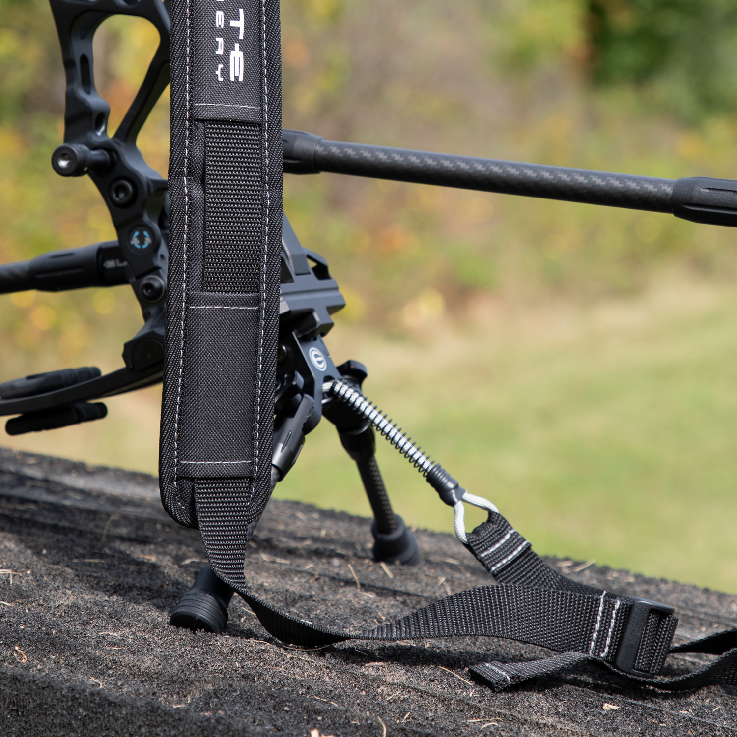 Elite compound bow with bipod stand deployed in hunting field setting