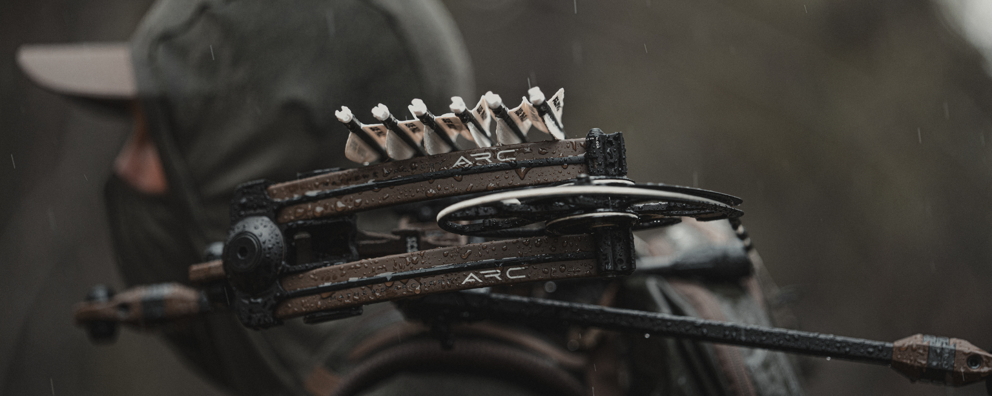 Mathews ARC compound bow carried in the rain — available at Fether Archery in Hillsdale, MI